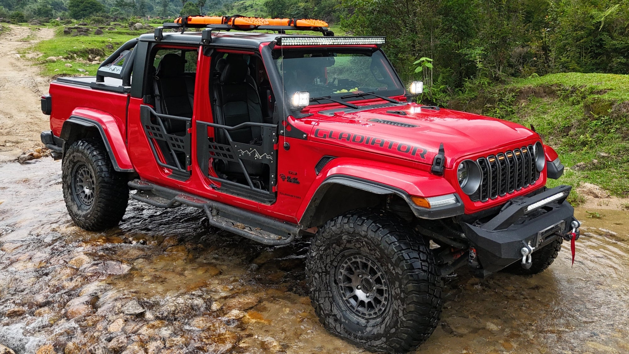 Jeep Gladiator JT truck bed rack installed with cargo setup shown from drone aerial view