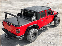 Pickup truck with installed bed rack shown from rear in outdoor setting